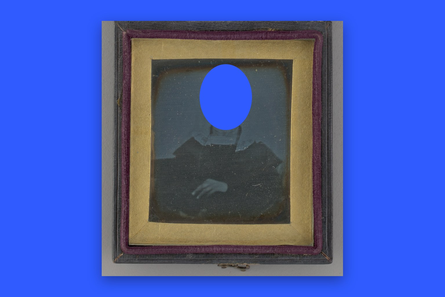 An 1842 daguerreotype portrait of a woman by an unknown maker, with the face cut out to a flat cobalt blue backdrop